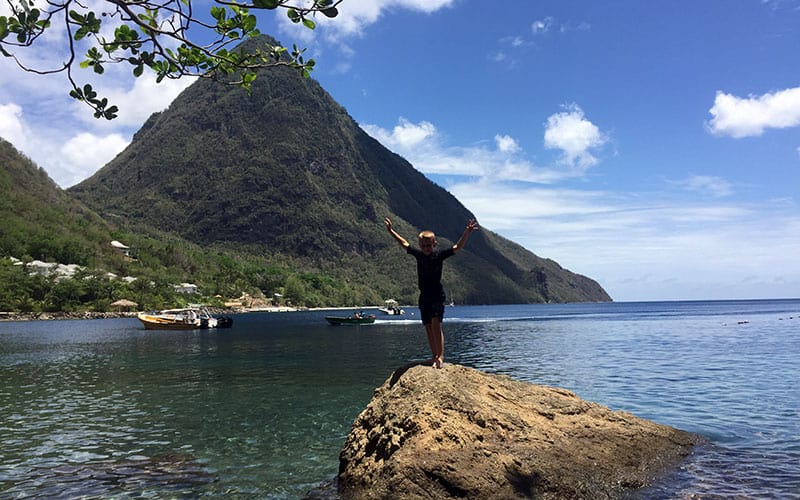 Child stands on a rock at Jalousie/Sugar Beach, Spencer Ambrose Tours, St. Lucia